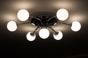 Fancy light fixture with round bulbs hanging from the ceiling.