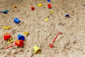 Sandbox filled with toys.